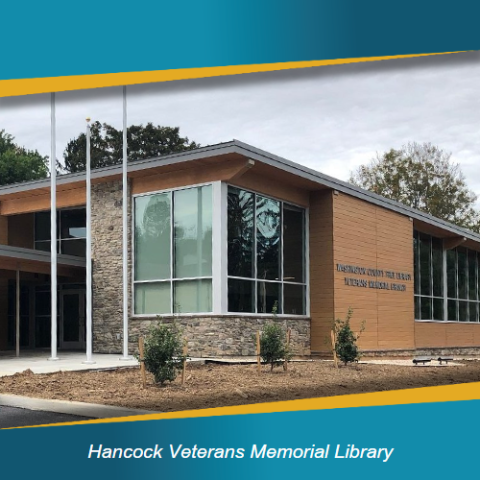 Hancock Veterans Memorial Library building with gray sky behind.