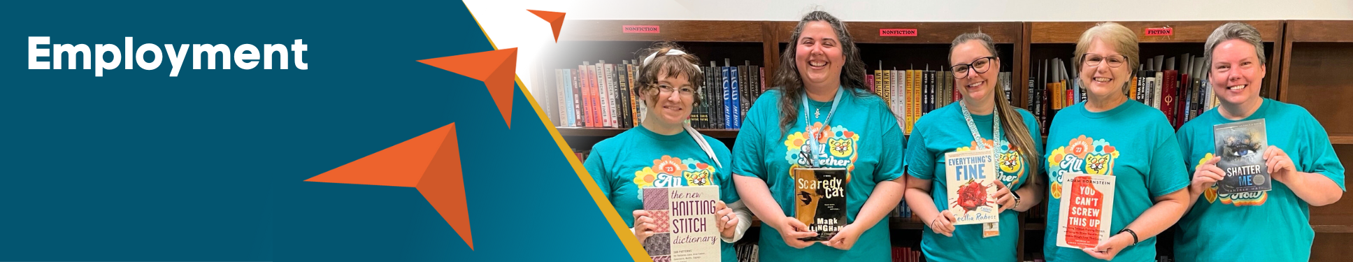 Group of people wearing green SRC shirts each holding a book.